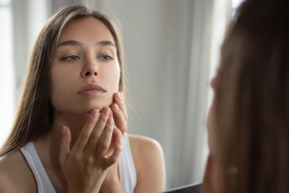 face mapping - woman checking her pimples and breakouts